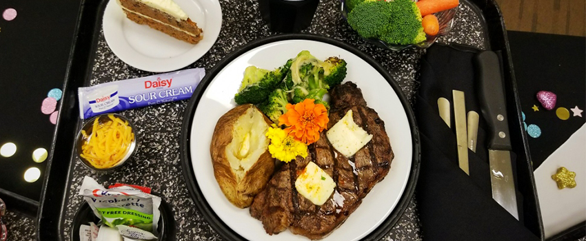 hospital meal of strip steak a a potato and veggies