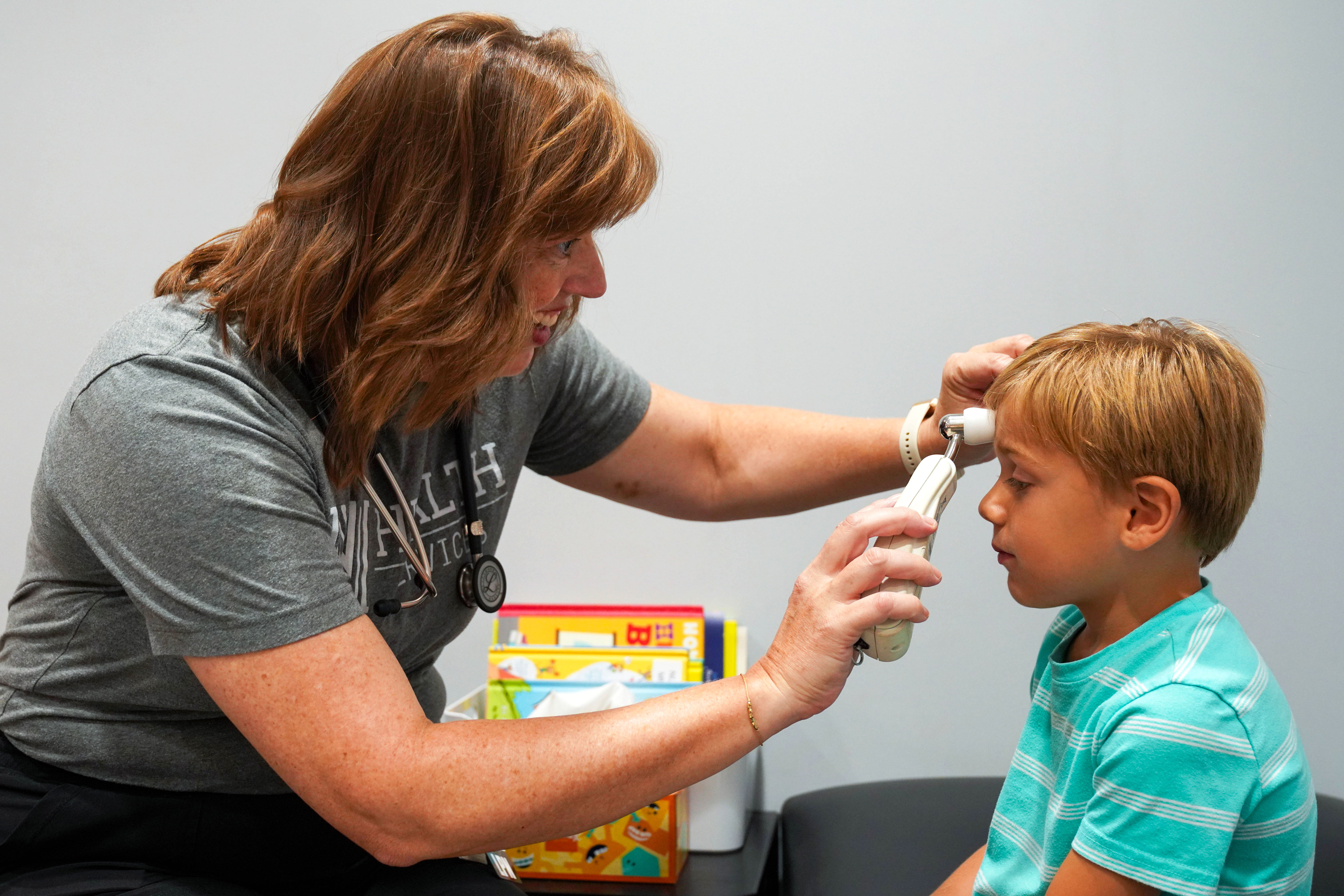 Norman School nurse checking temperature